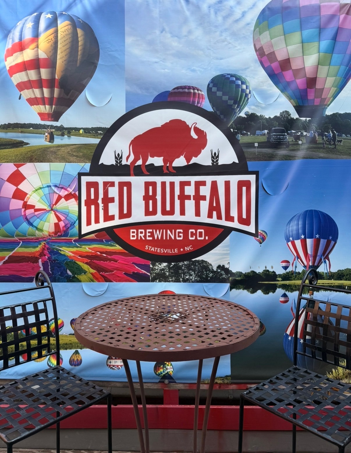 Red Buffalo Brewing Co. outdoor banner with hot air balloons in downtown Statesville